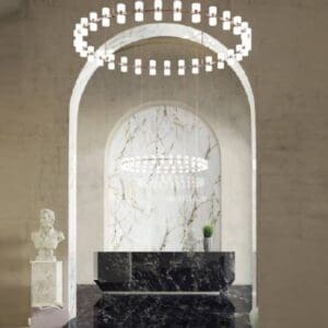 A marble wall with a black counter and white walls